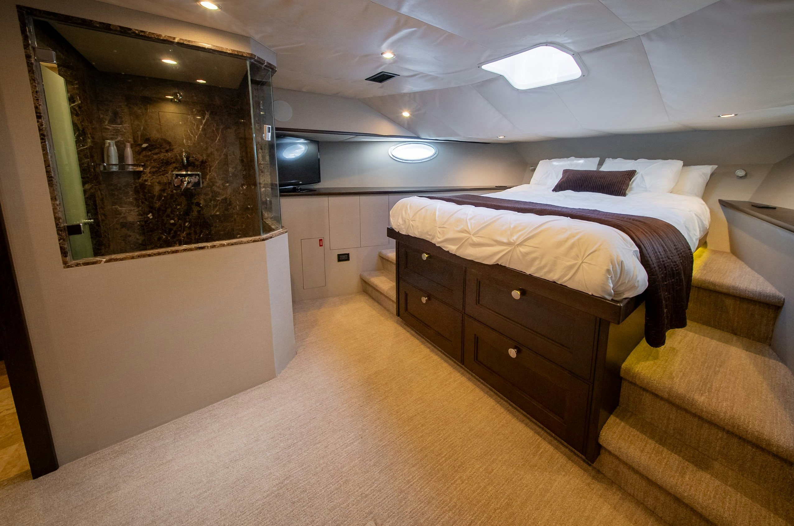 a bedroom with a large mirror aboard ENCORE Yacht for Sale