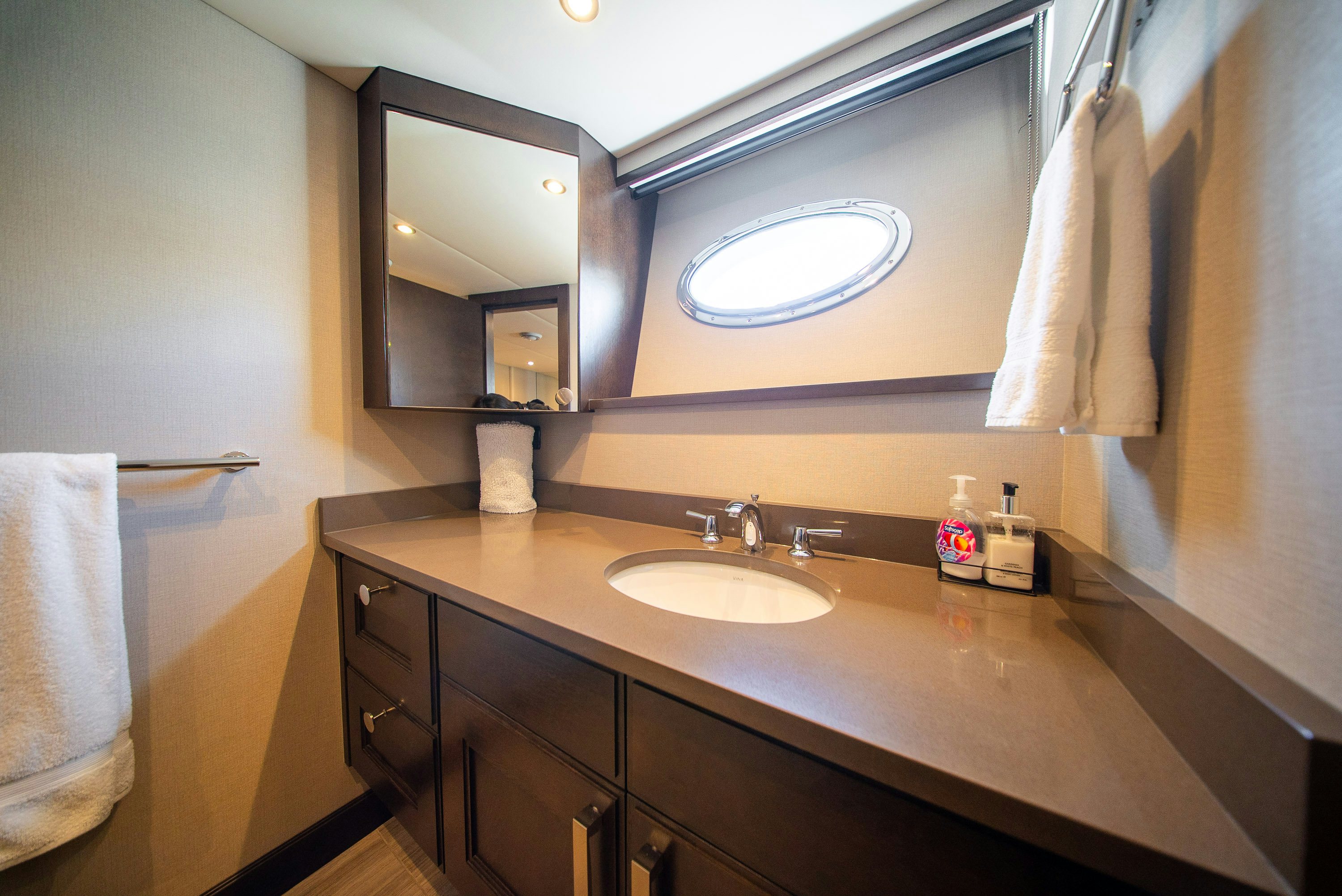 a bathroom with a large mirror aboard ENCORE Yacht for Sale