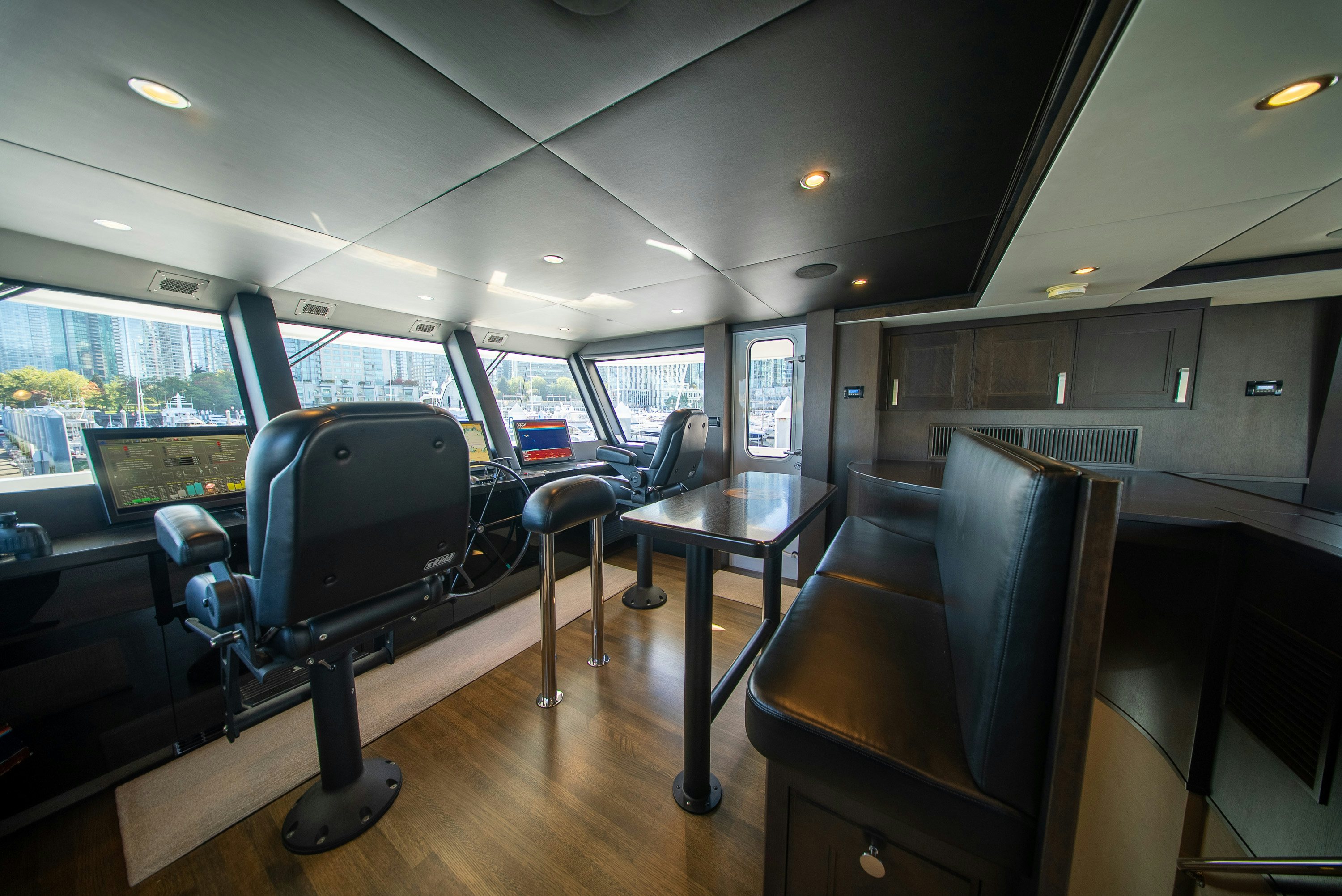 inside of a vehicle with a table and chairs and a large window aboard ENCORE Yacht for Sale