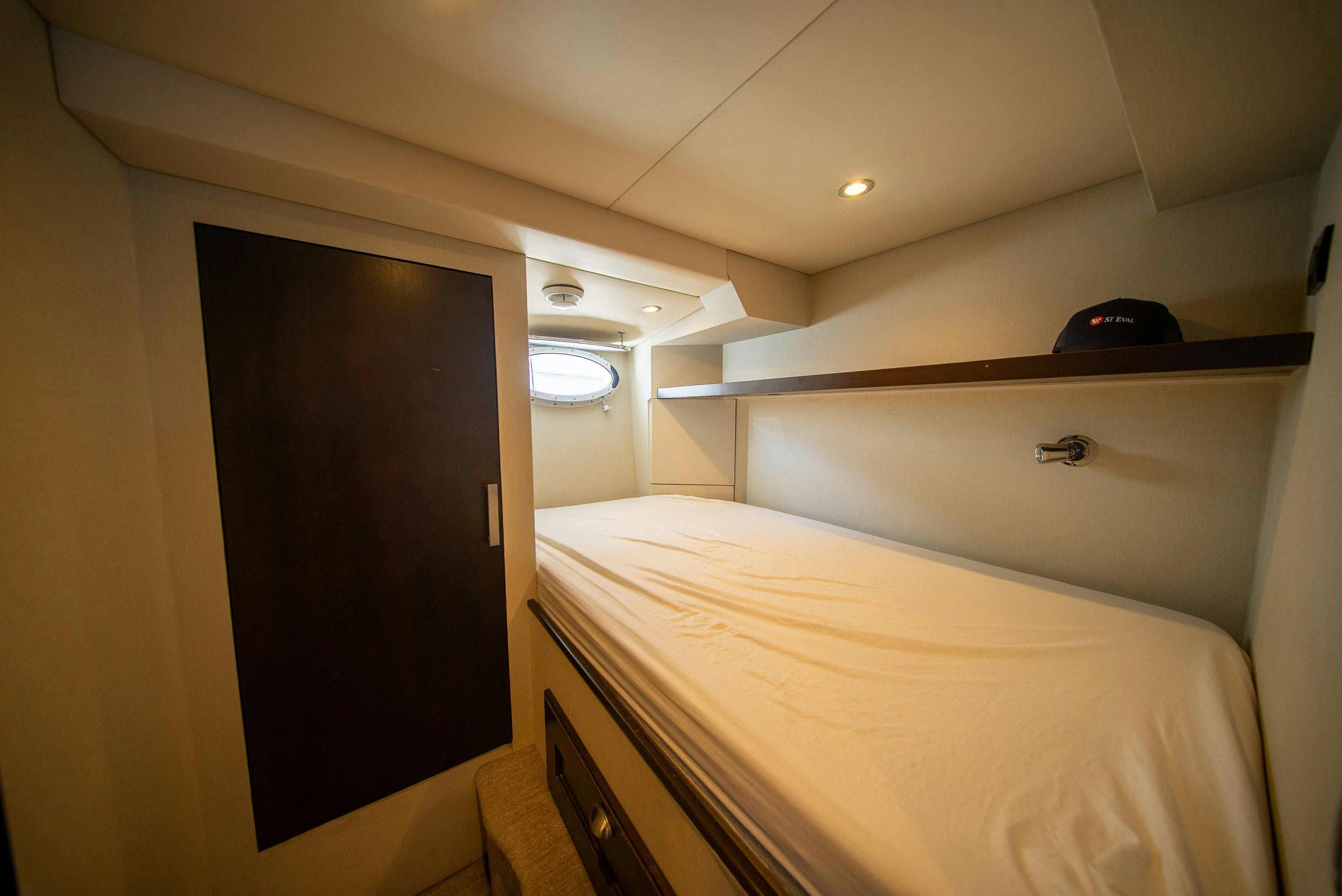 a bedroom with a bed and a closet aboard ENCORE Yacht for Sale