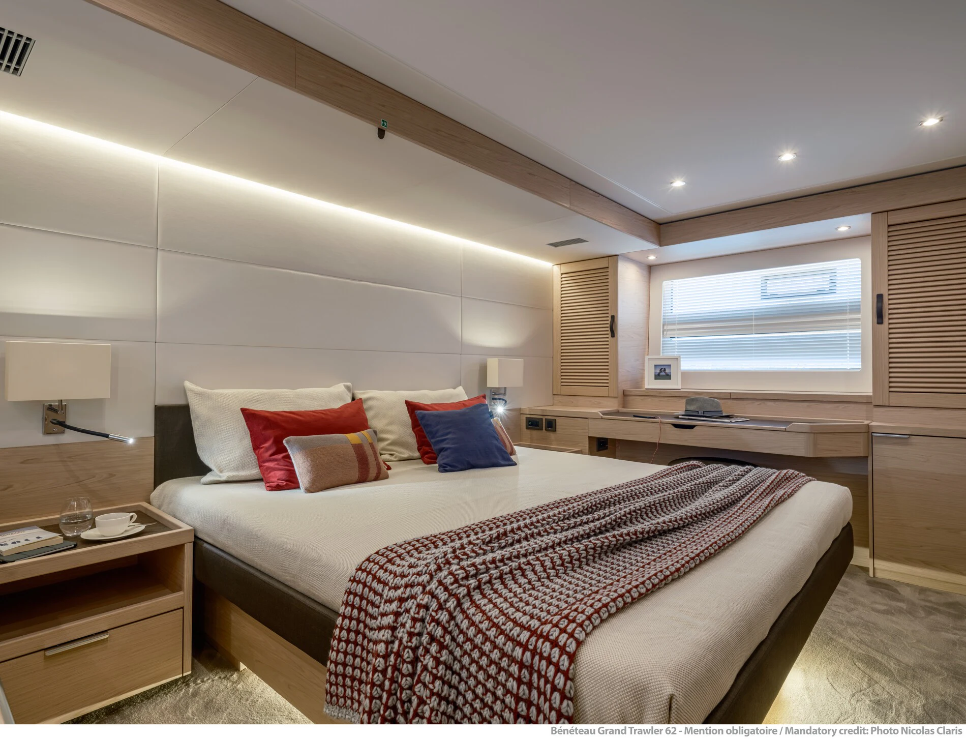 a bedroom with a bed and a desk aboard ABIDE AWHILE Yacht for Sale