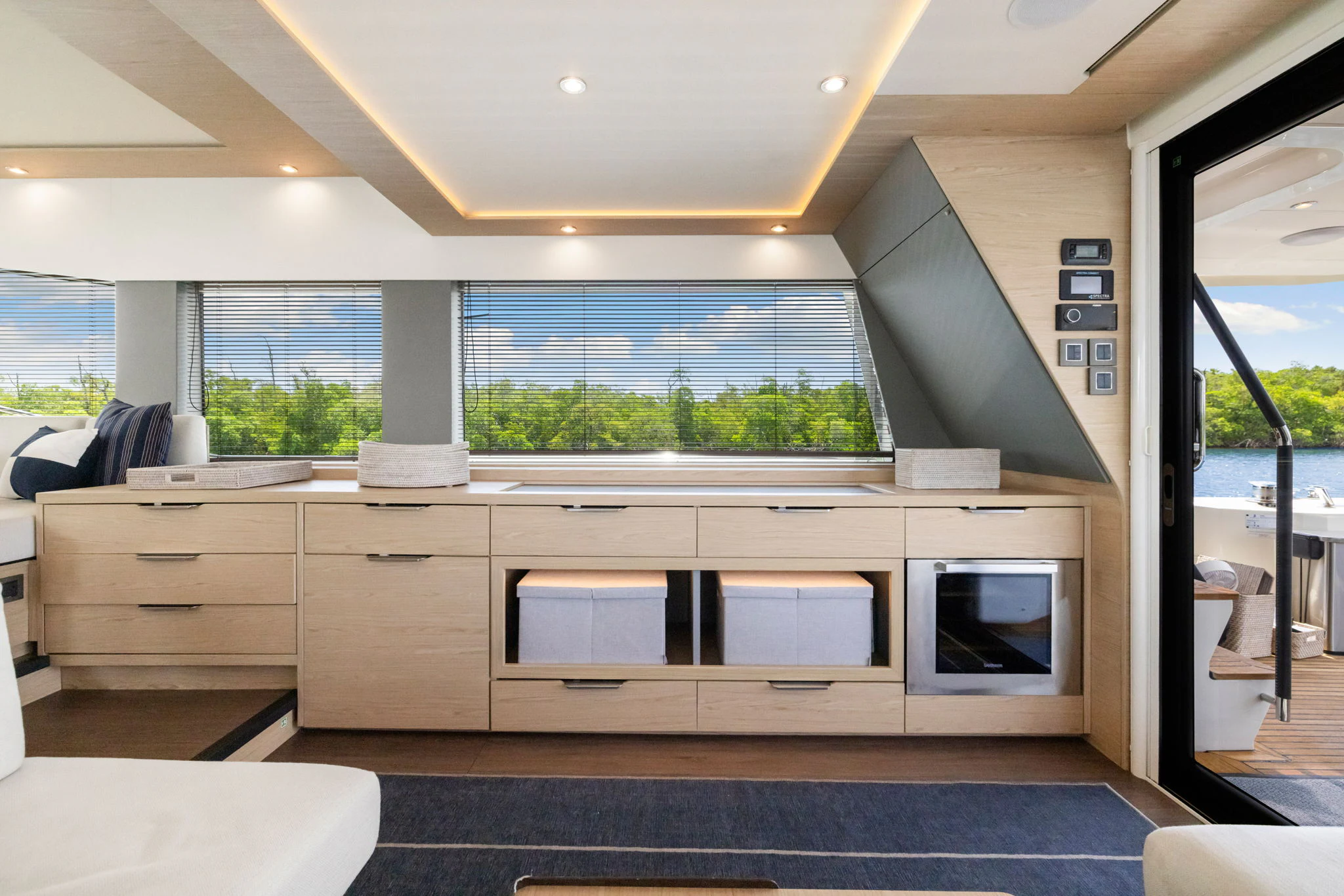 a room with a large window and a desk with a computer on it aboard ABIDE AWHILE Yacht for Sale