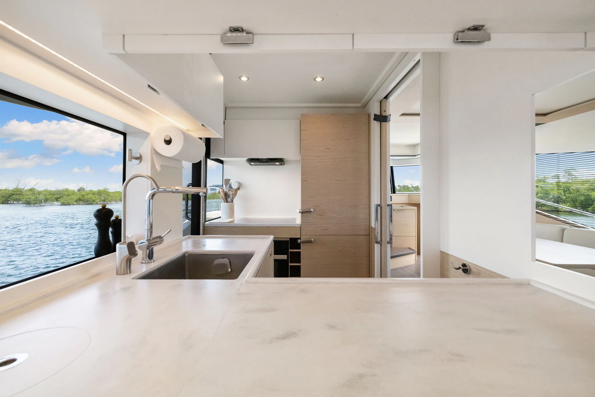 a large white kitchen with a large window aboard ABIDE AWHILE Yacht for Sale