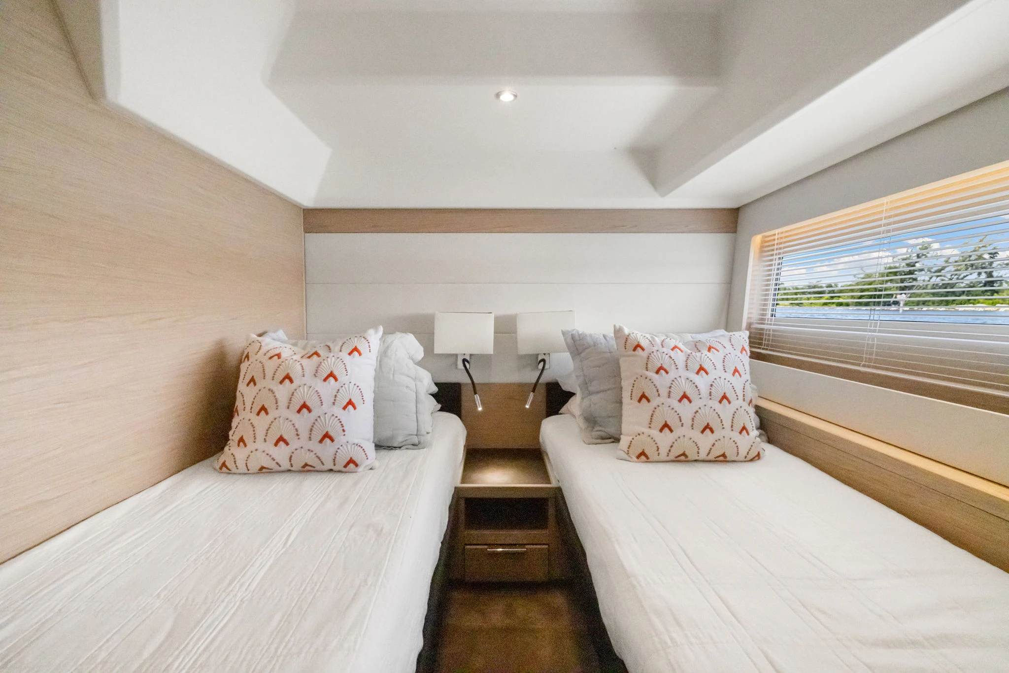 a bedroom with a bed and a window aboard ABIDE AWHILE Yacht for Sale