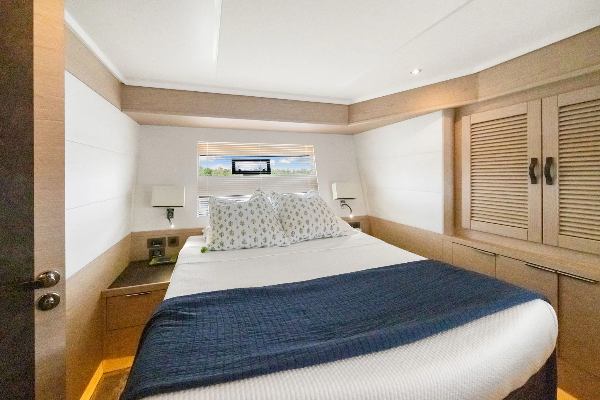 a bedroom with a bed and a desk aboard ABIDE AWHILE Yacht for Sale