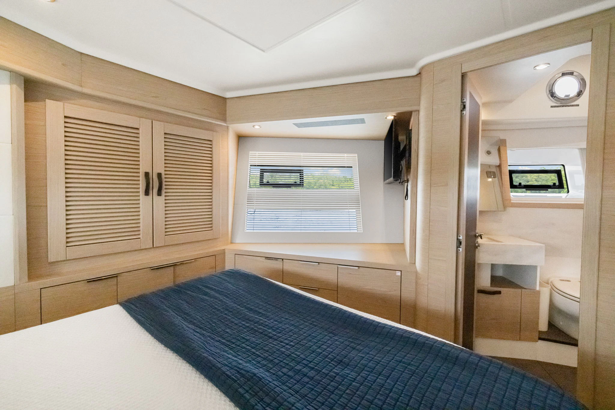 a bedroom with a bed and a closet aboard ABIDE AWHILE Yacht for Sale