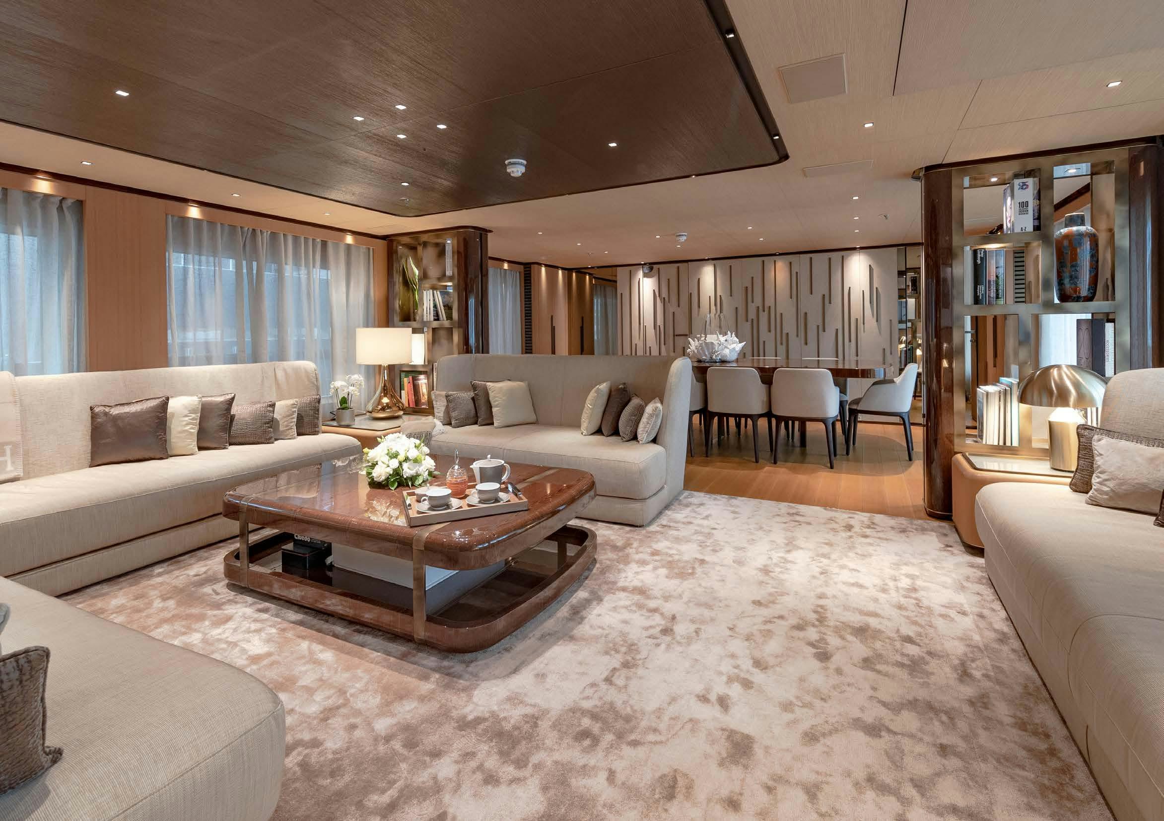 a living room with a large white rug and a table aboard VERTIGE Yacht for Sale