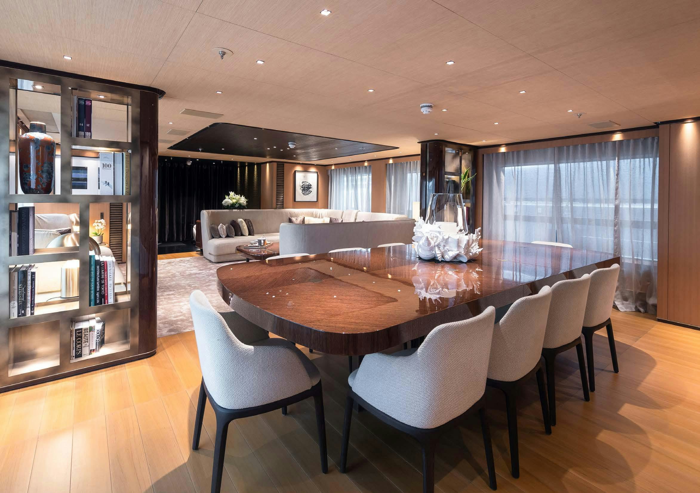 a large dining table in a living room aboard VERTIGE Yacht for Sale