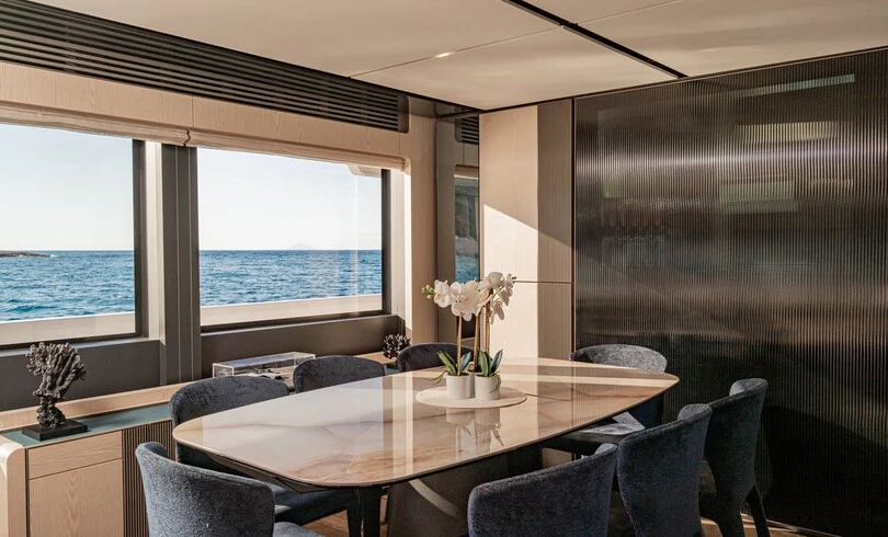 a room with a table and chairs aboard TRILOGY Yacht for Charter