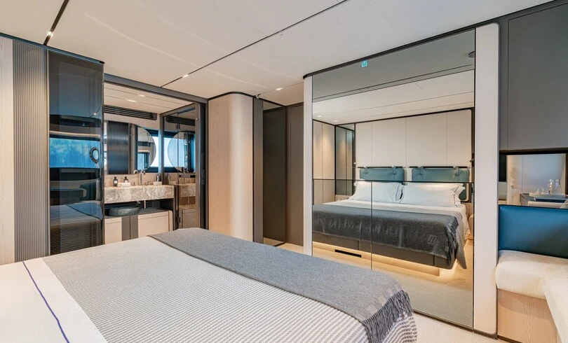 a bedroom with a bed and a sink aboard TRILOGY Yacht for Charter
