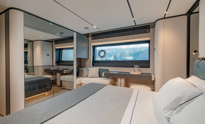 a room with a bed and a tv aboard TRILOGY Yacht for Charter