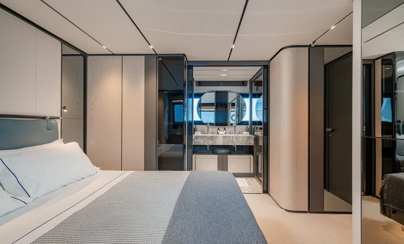 a room with a bed and a door aboard TRILOGY Yacht for Charter