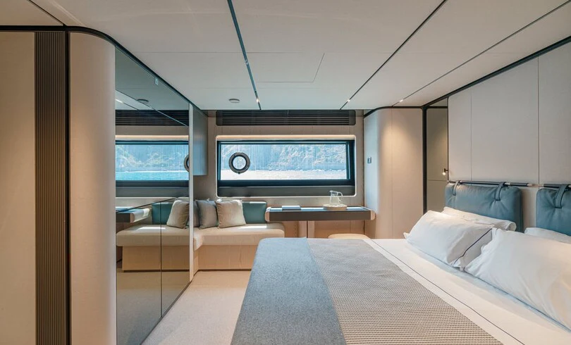 a room with a bed and a tv aboard TRILOGY Yacht for Charter