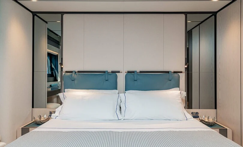 a bed with white sheets aboard TRILOGY Yacht for Charter