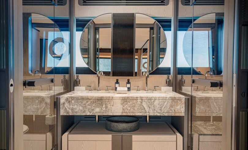 a bathroom with a large mirror aboard TRILOGY Yacht for Charter