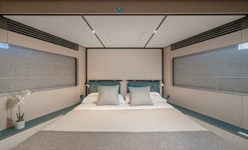 a bed with white sheets aboard TRILOGY Yacht for Charter