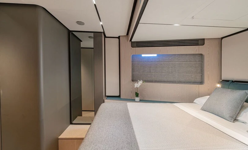 a room with a bed and a window aboard TRILOGY Yacht for Charter