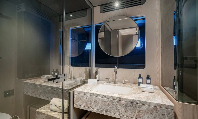 a bathroom with a large mirror aboard TRILOGY Yacht for Charter