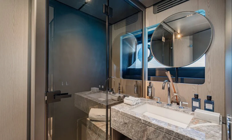 a bathroom with a large mirror aboard TRILOGY Yacht for Charter
