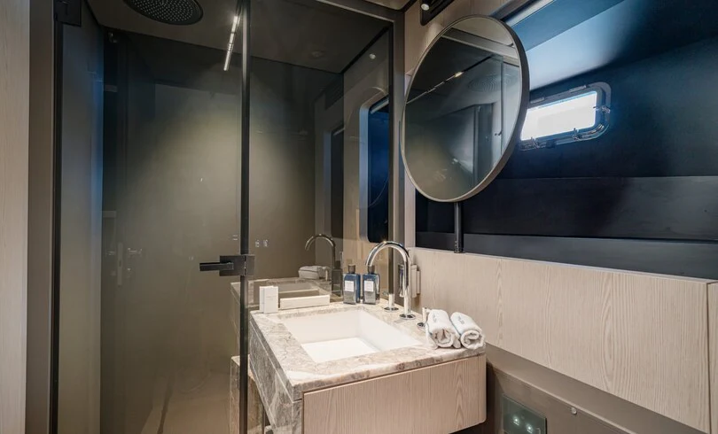 a bathroom with a large mirror aboard TRILOGY Yacht for Charter