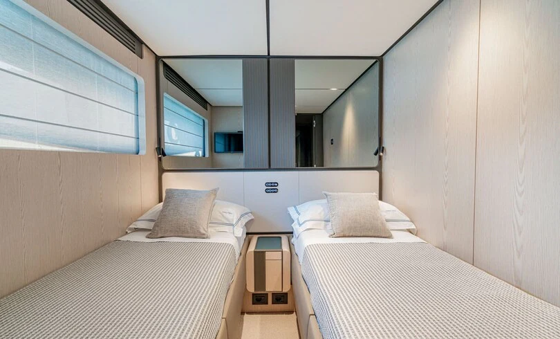 a couple of beds in a room aboard TRILOGY Yacht for Charter
