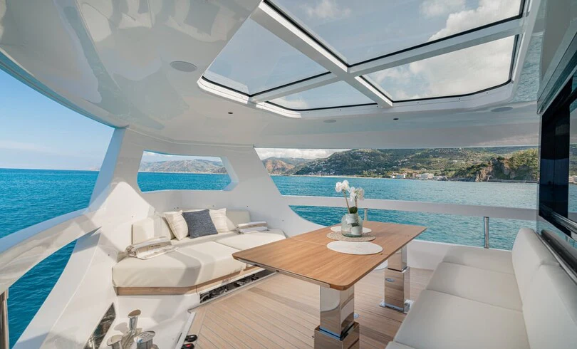 a room with a table and a bed aboard TRILOGY Yacht for Charter
