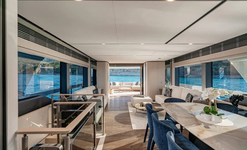 a living room with a large window aboard TRILOGY Yacht for Charter