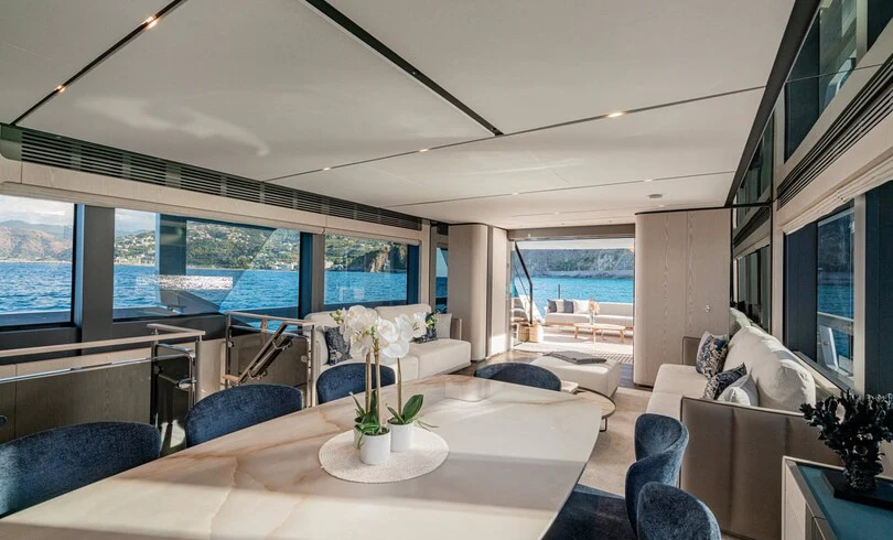 a living room with a large window aboard TRILOGY Yacht for Charter