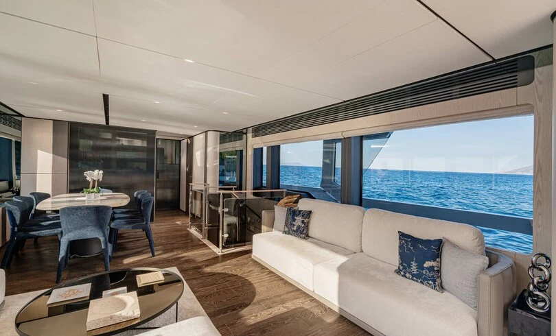a living room with a large window aboard TRILOGY Yacht for Charter