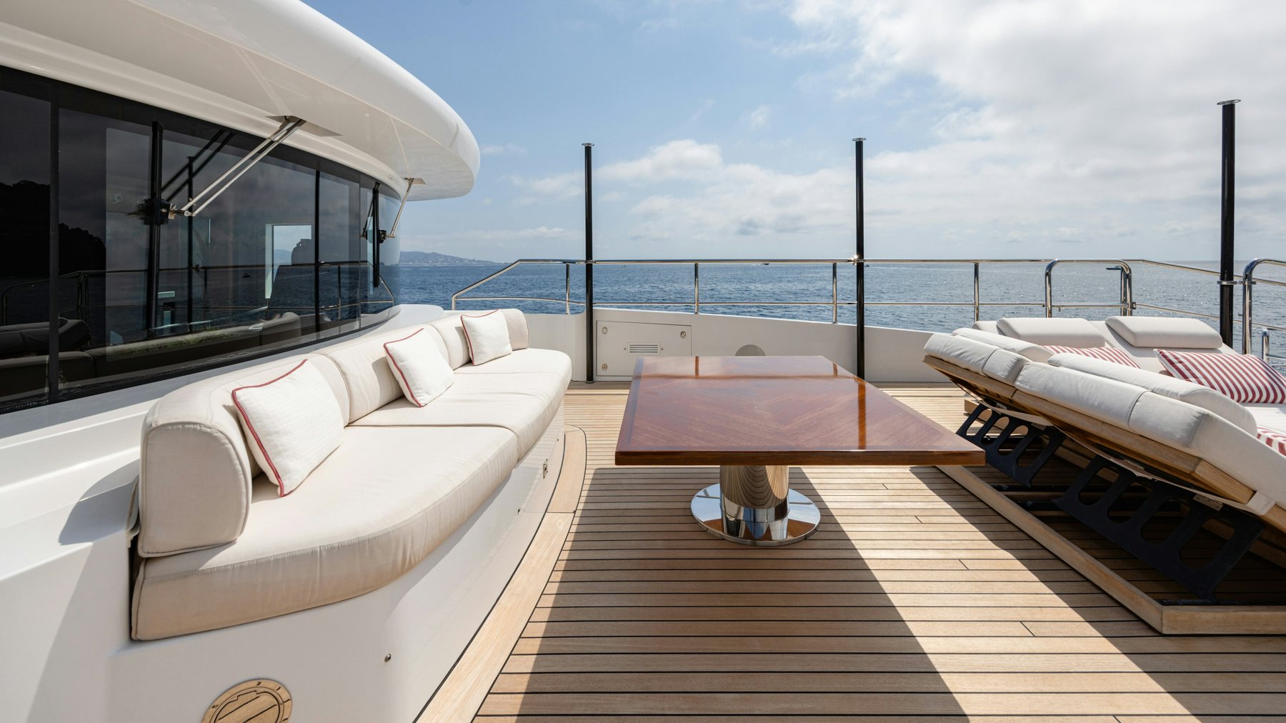a room with a bed and a table and chairs aboard BELLA VITA Yacht for Sale