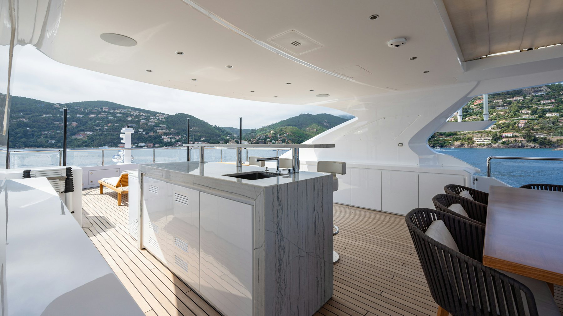 a room with a large white table and chairs and a large white building with a large white tower aboard BELLA VITA Yacht for Sale