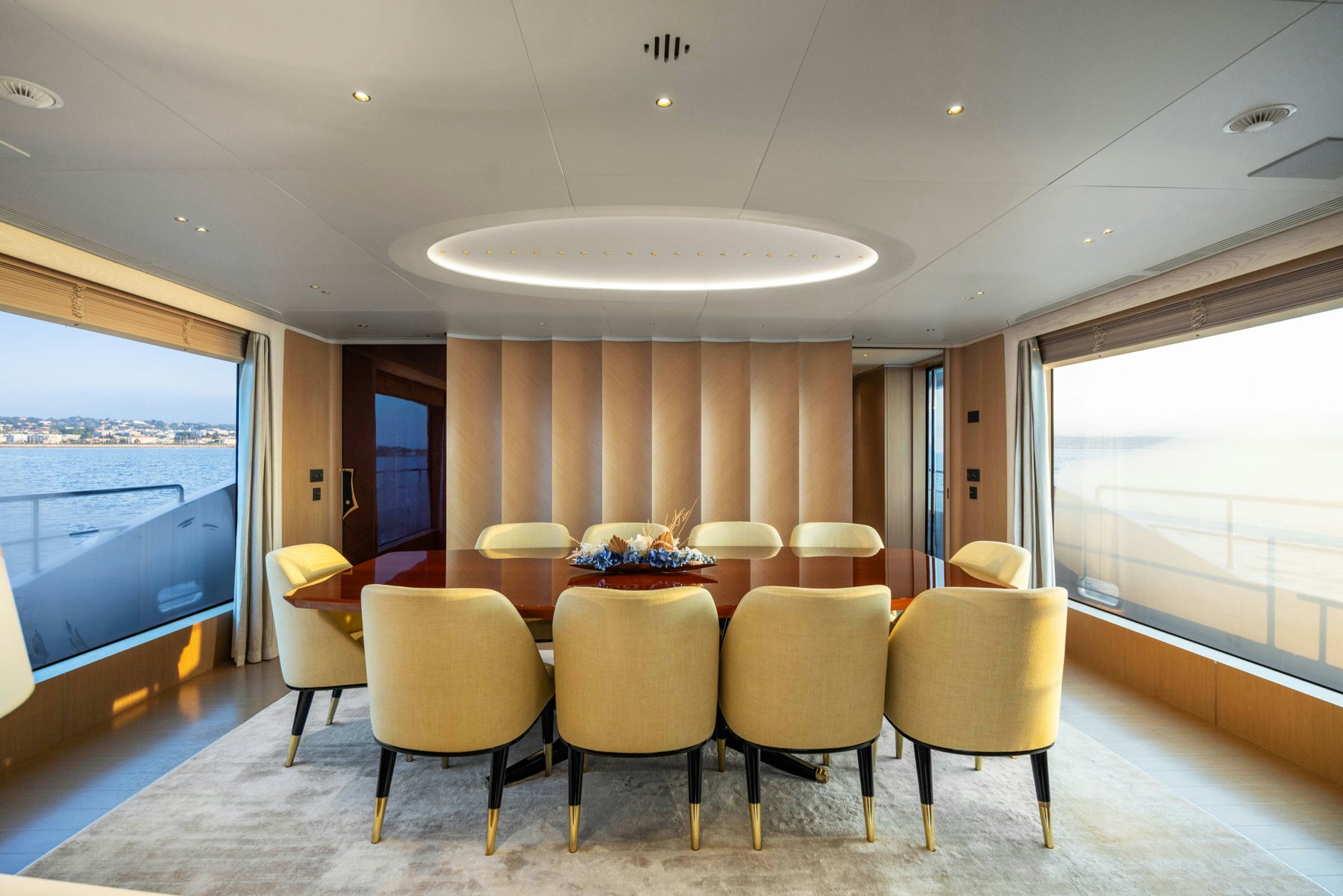 a room with tables and chairs aboard BELLA VITA Yacht for Sale