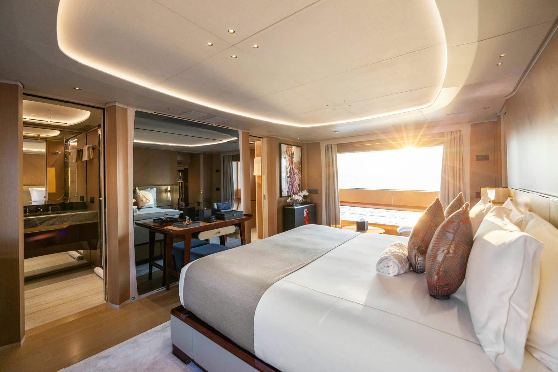 a bedroom with a bed and a table aboard BELLA VITA Yacht for Sale