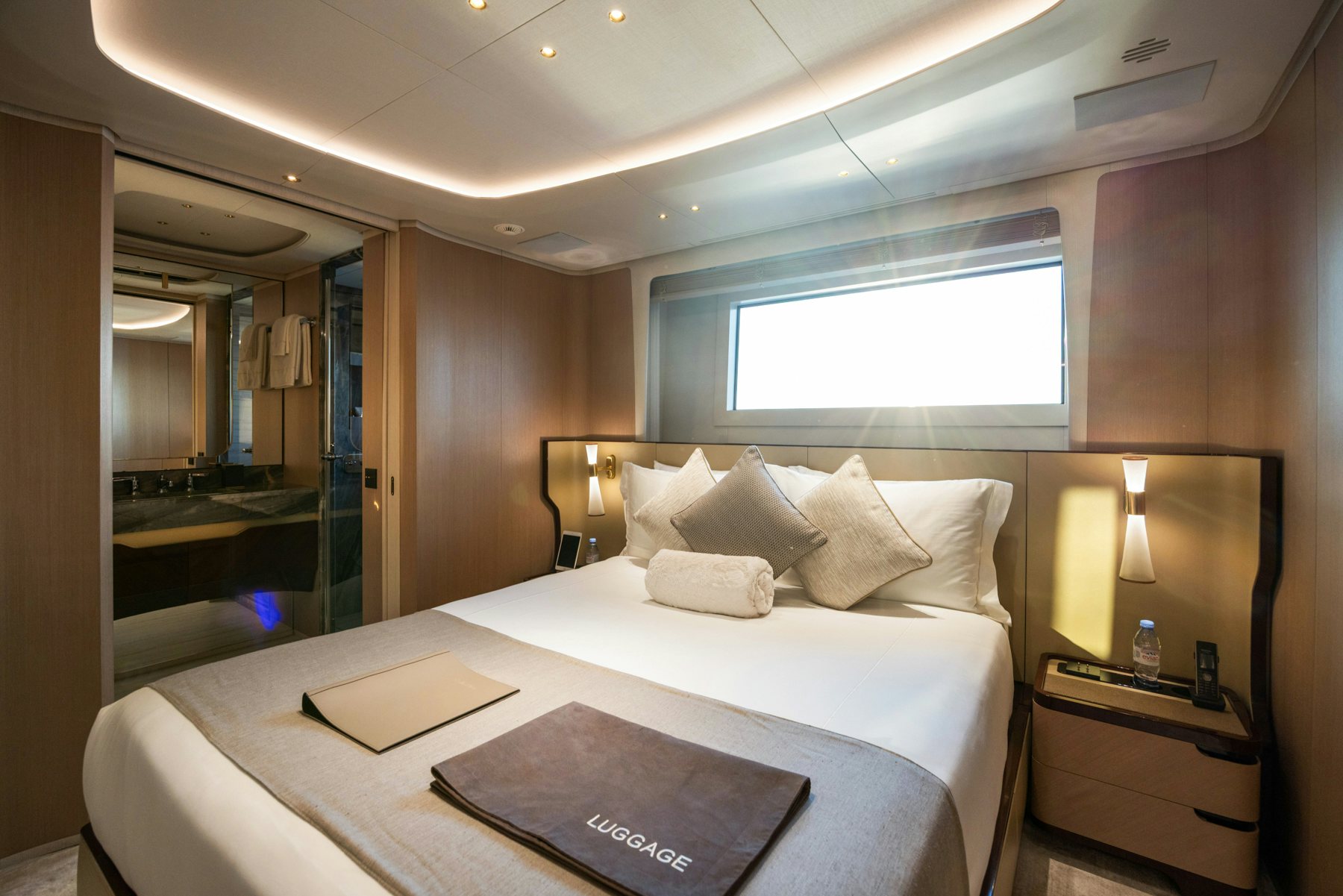 a hotel room with a bed and a mirror aboard BELLA VITA Yacht for Sale