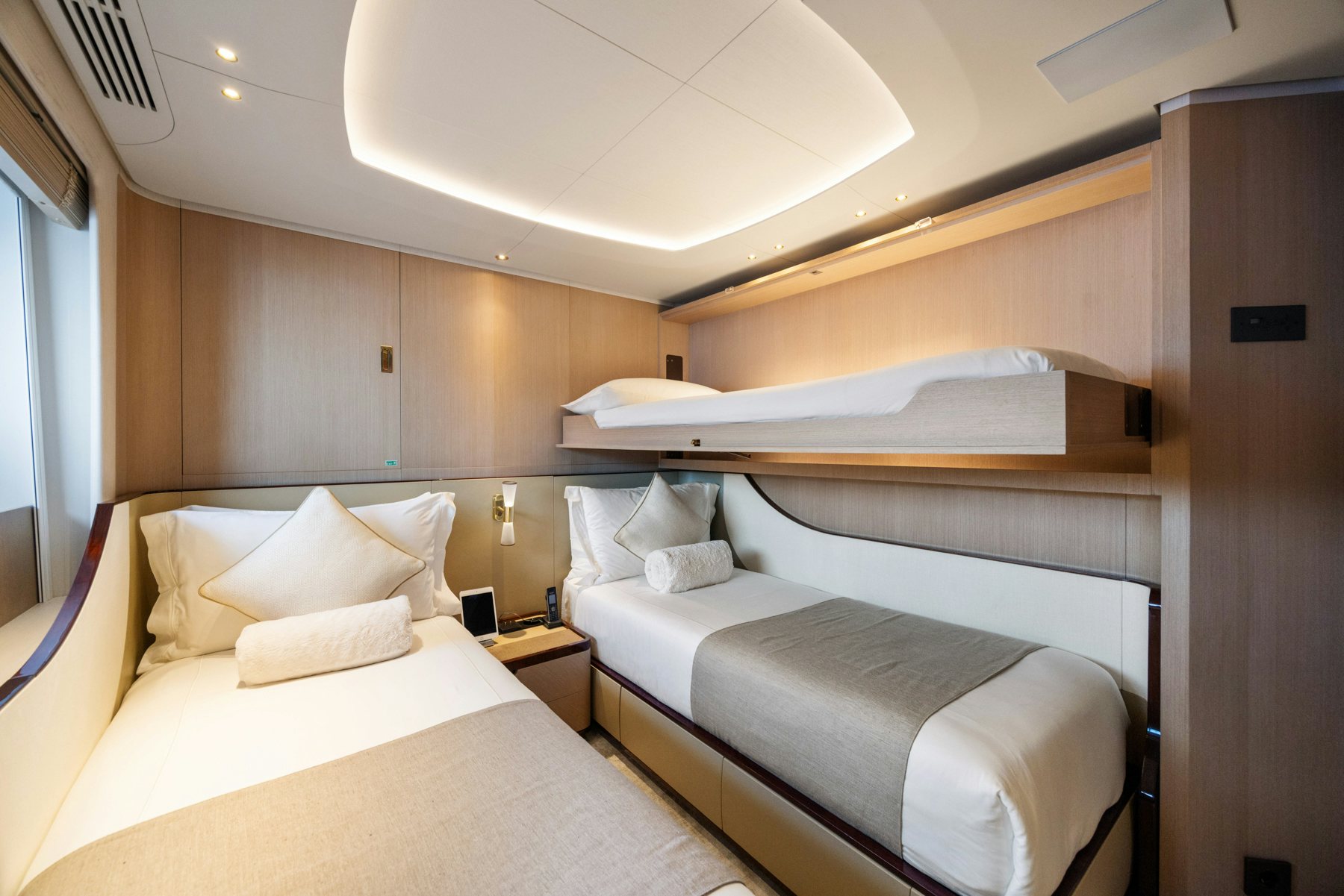 a room with beds and a window aboard BELLA VITA Yacht for Sale