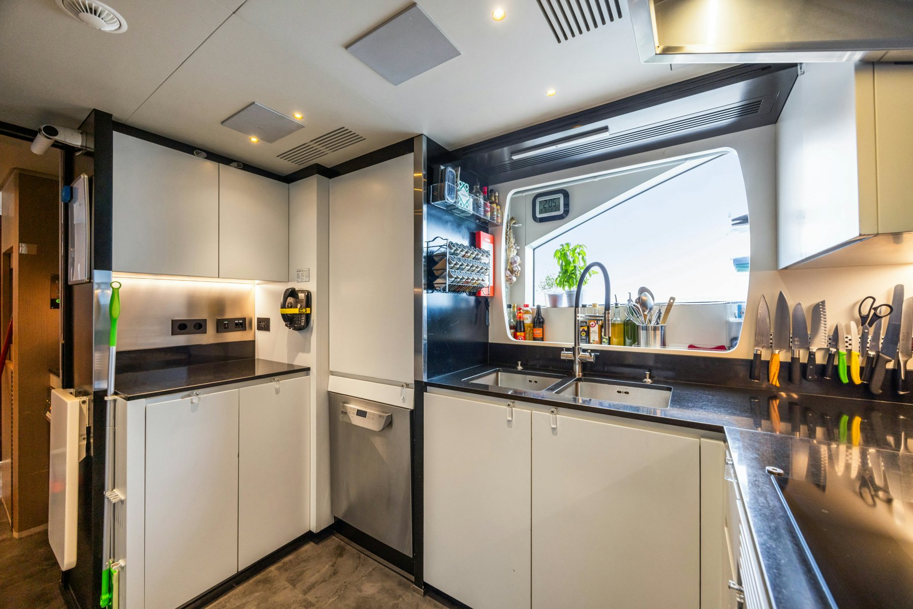 a kitchen with white cabinets aboard BELLA VITA Yacht for Sale