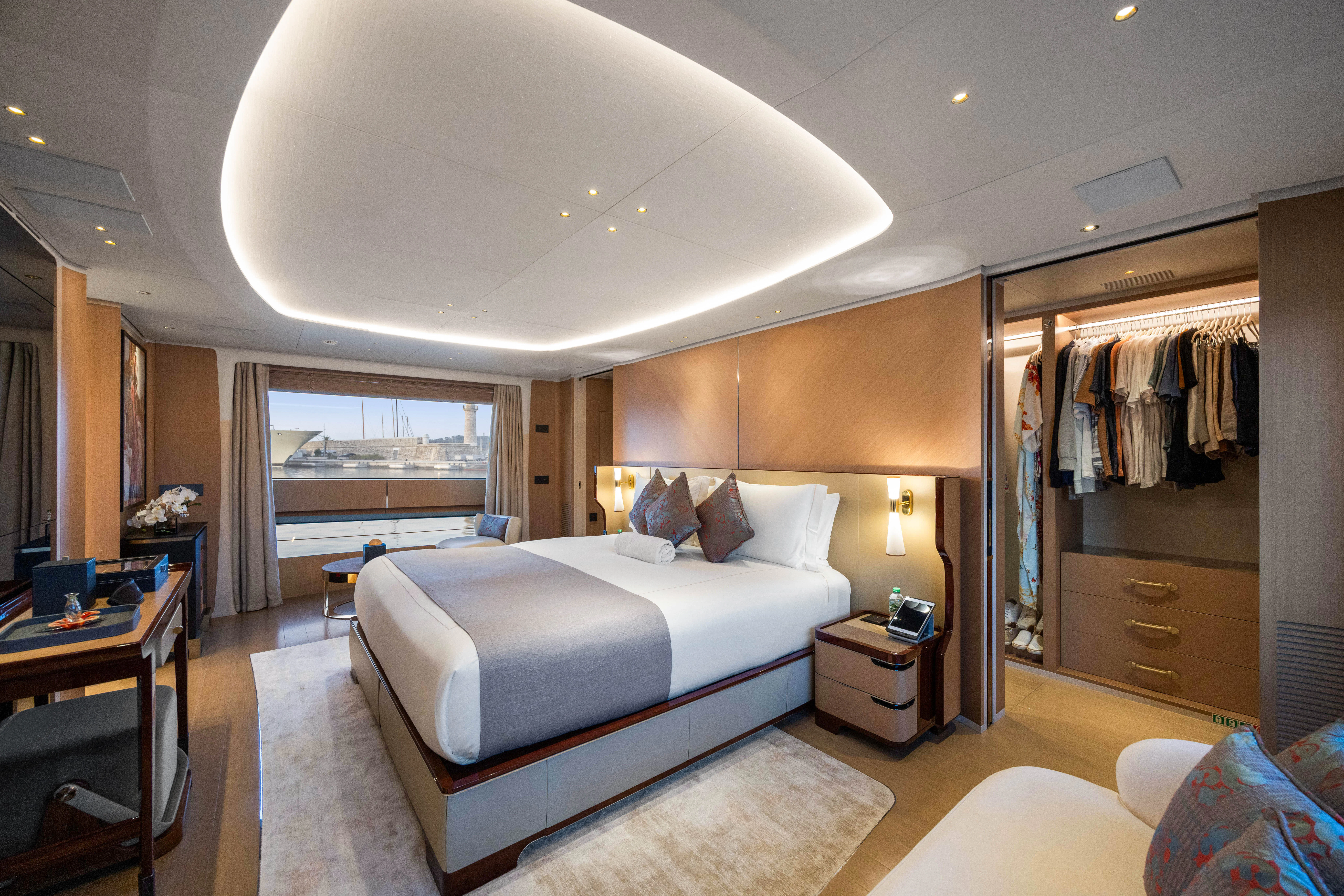 a bedroom with a bed and a closet aboard TRAMONTO Yacht for Charter
