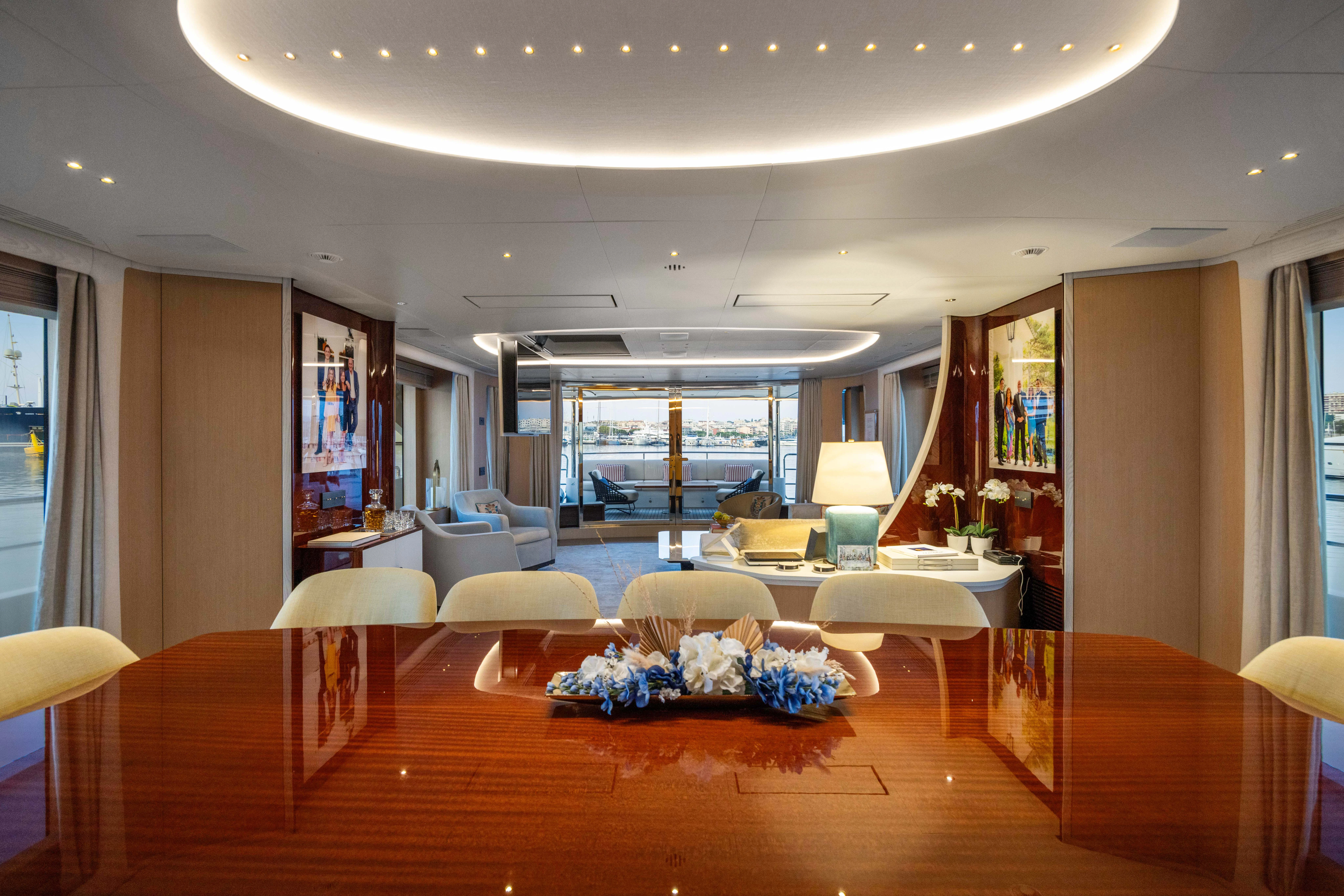 a room with a wood floor and a large window with a view of the water aboard TRAMONTO Yacht for Charter