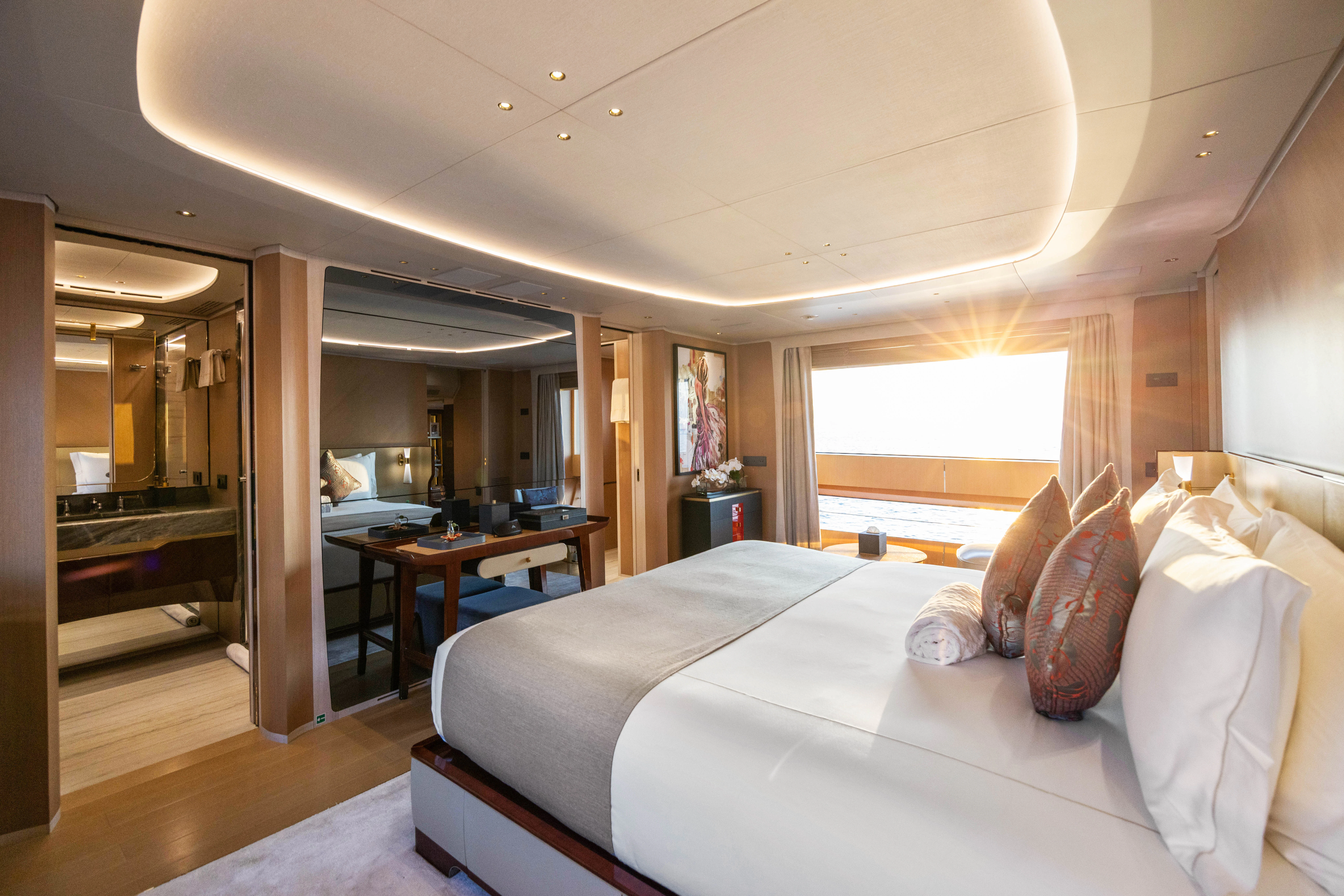 a bedroom with a bed and a table aboard TRAMONTO Yacht for Charter