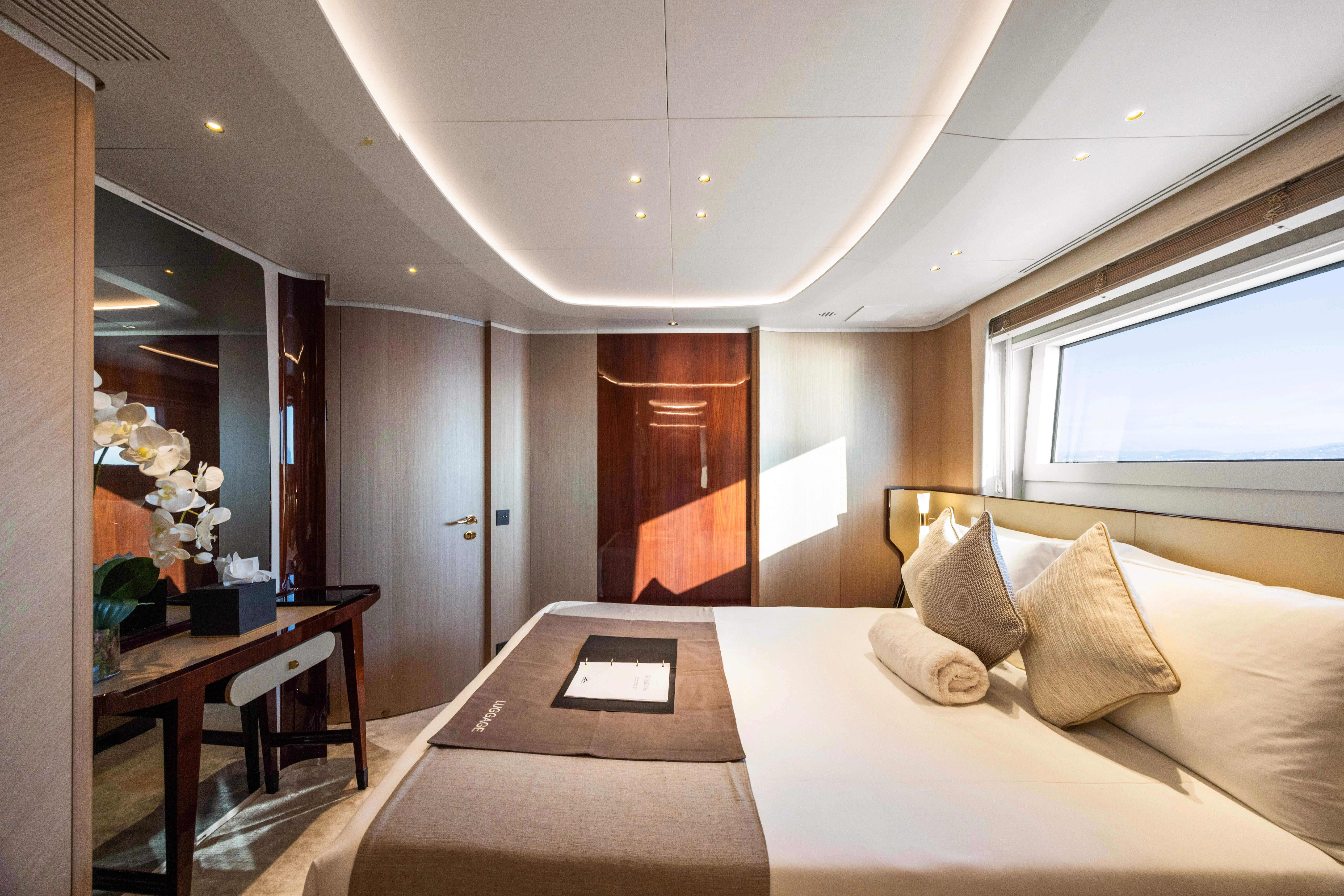 a hotel room with a bed and a table aboard TRAMONTO Yacht for Charter