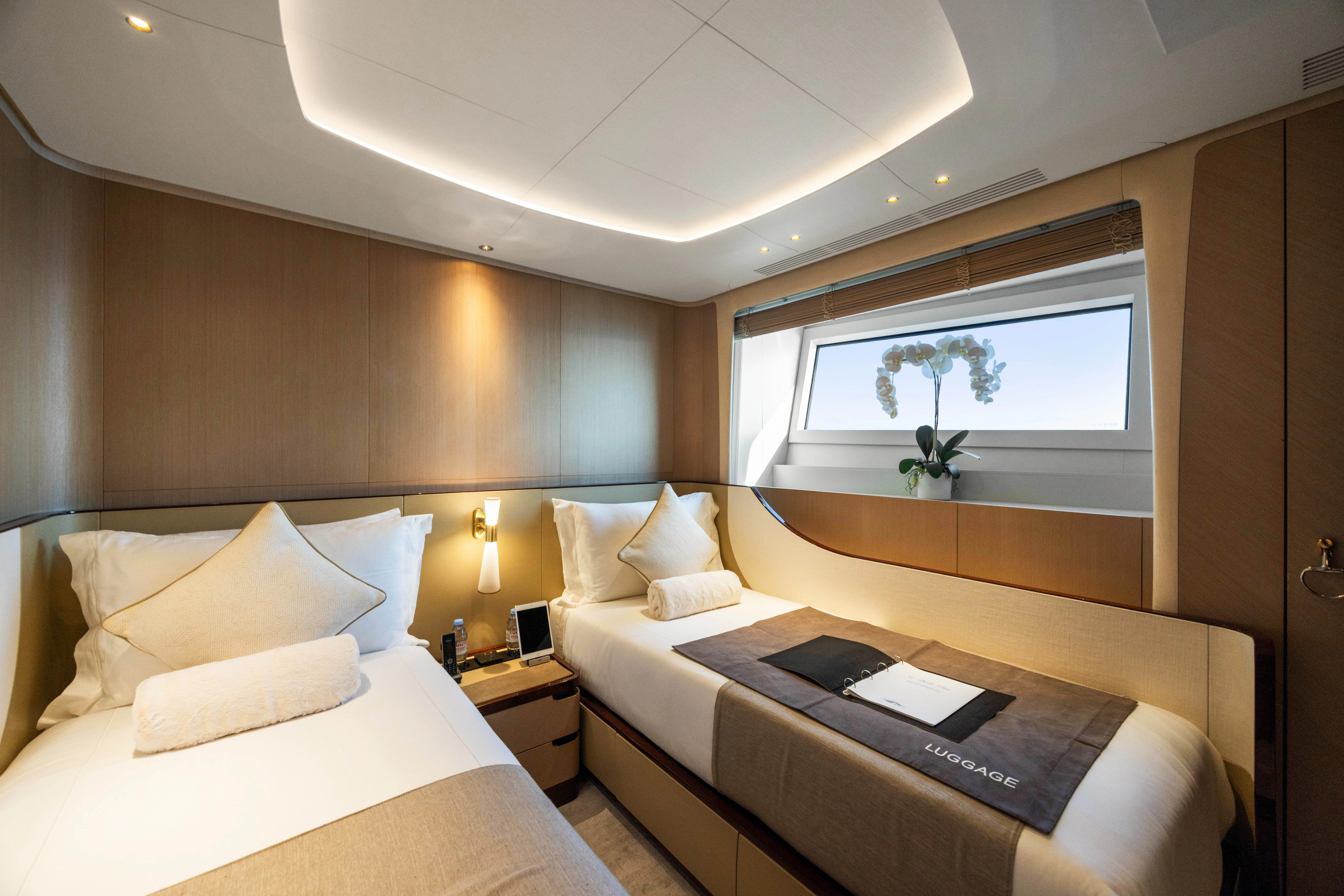 a room with a bed and a laptop on a table aboard TRAMONTO Yacht for Charter