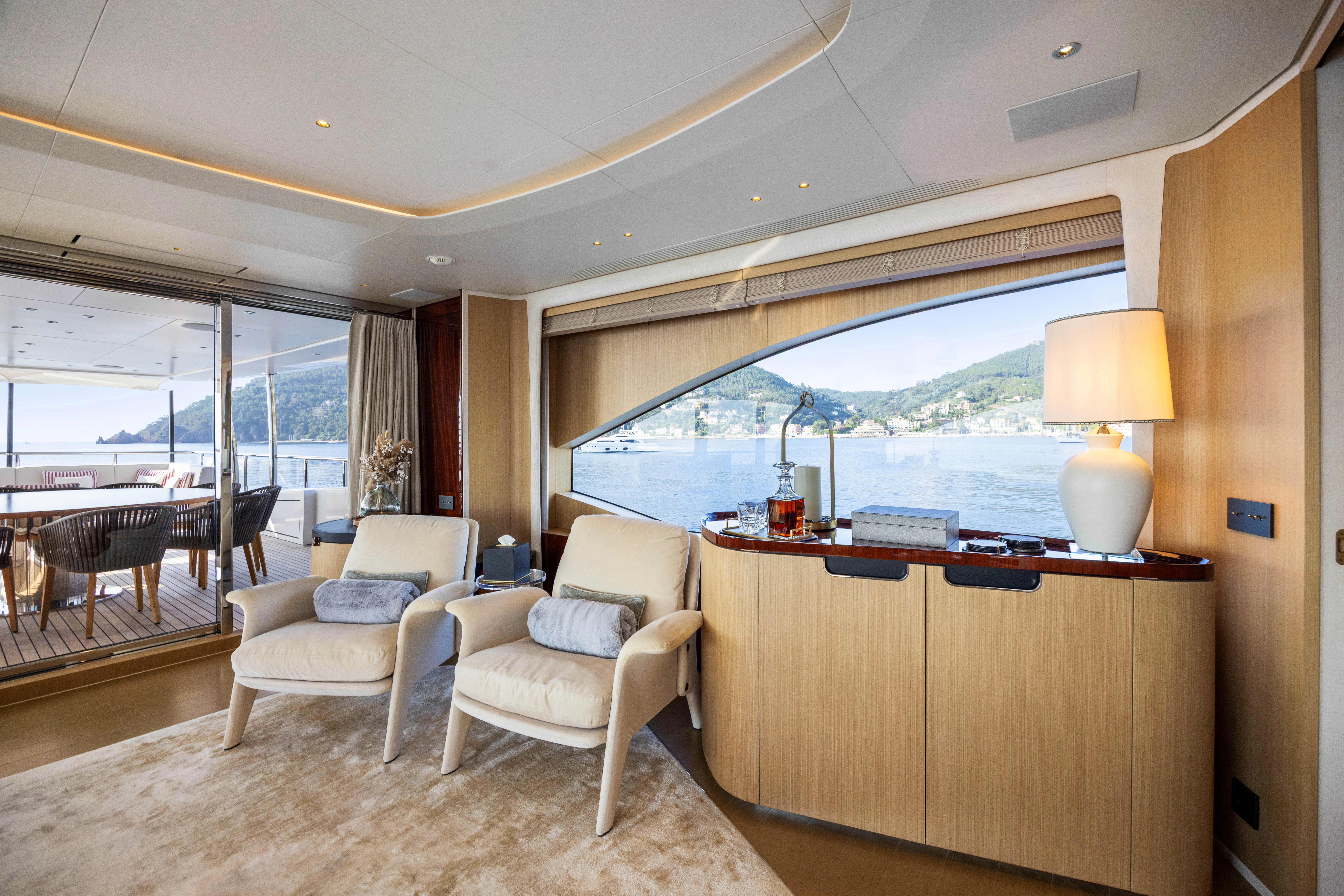 a living room with a large window aboard TRAMONTO Yacht for Charter