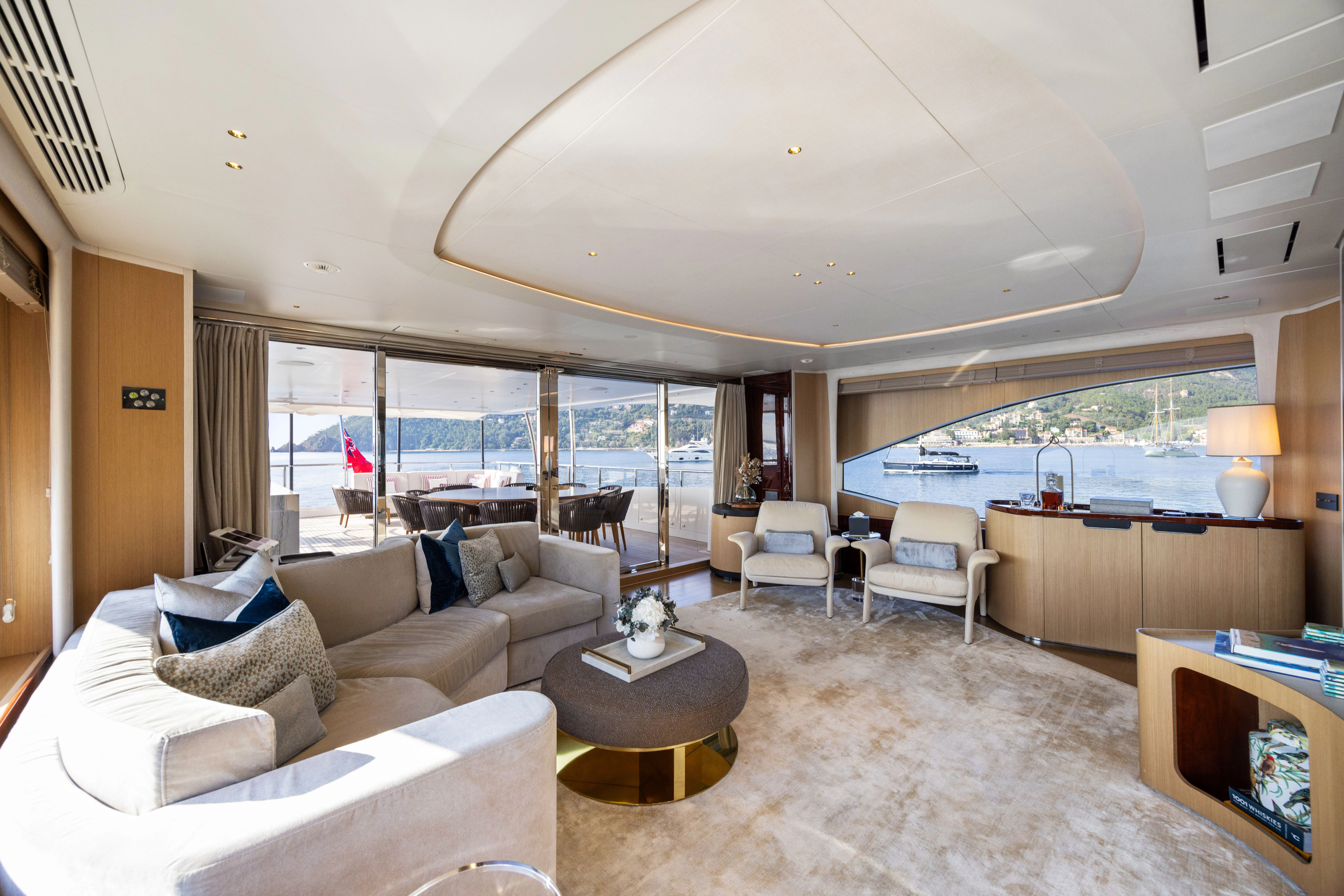 a living room with a large window aboard TRAMONTO Yacht for Charter