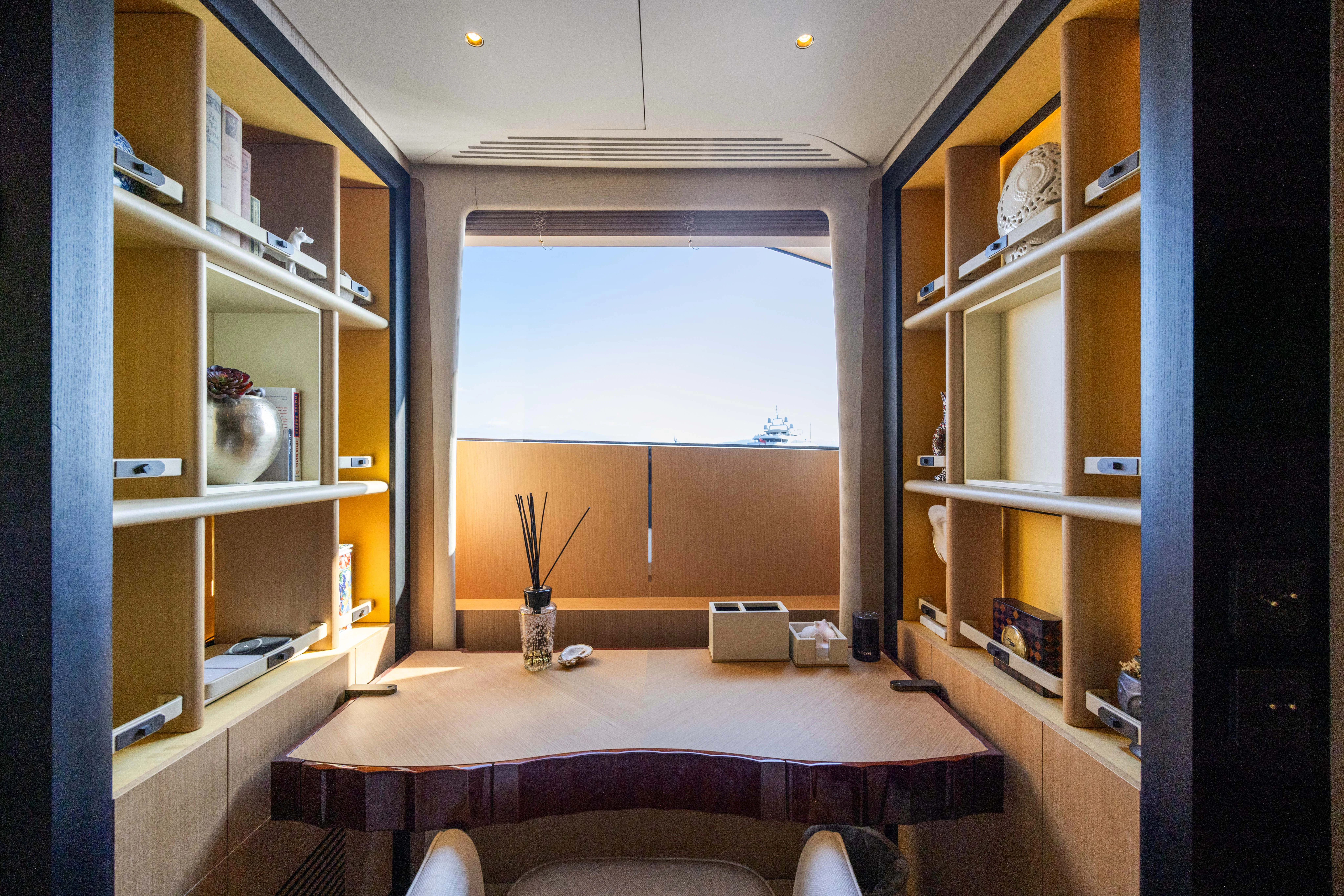a room with a table and a window aboard TRAMONTO Yacht for Charter