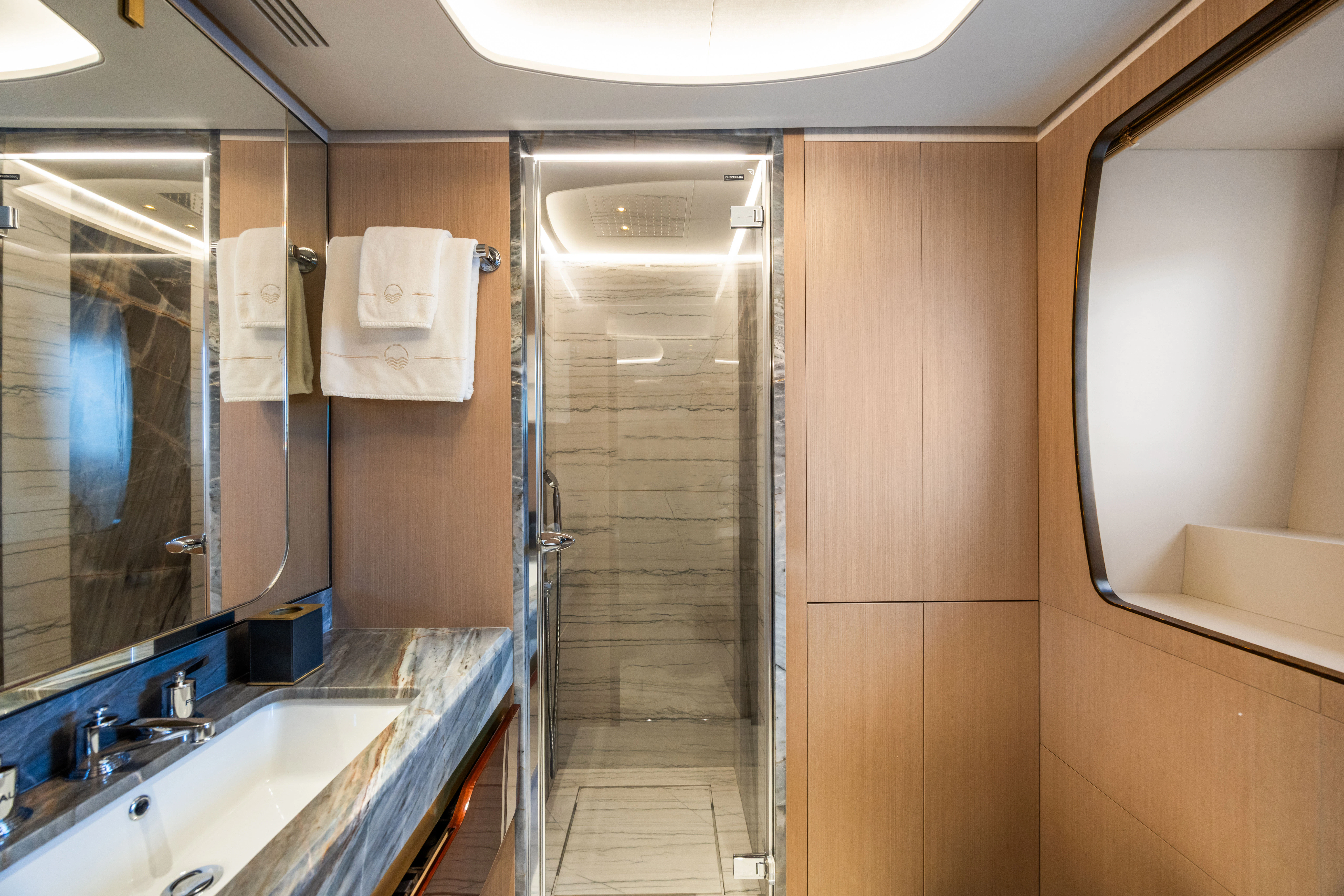 a bathroom with a shower unit and sink aboard TRAMONTO Yacht for Charter