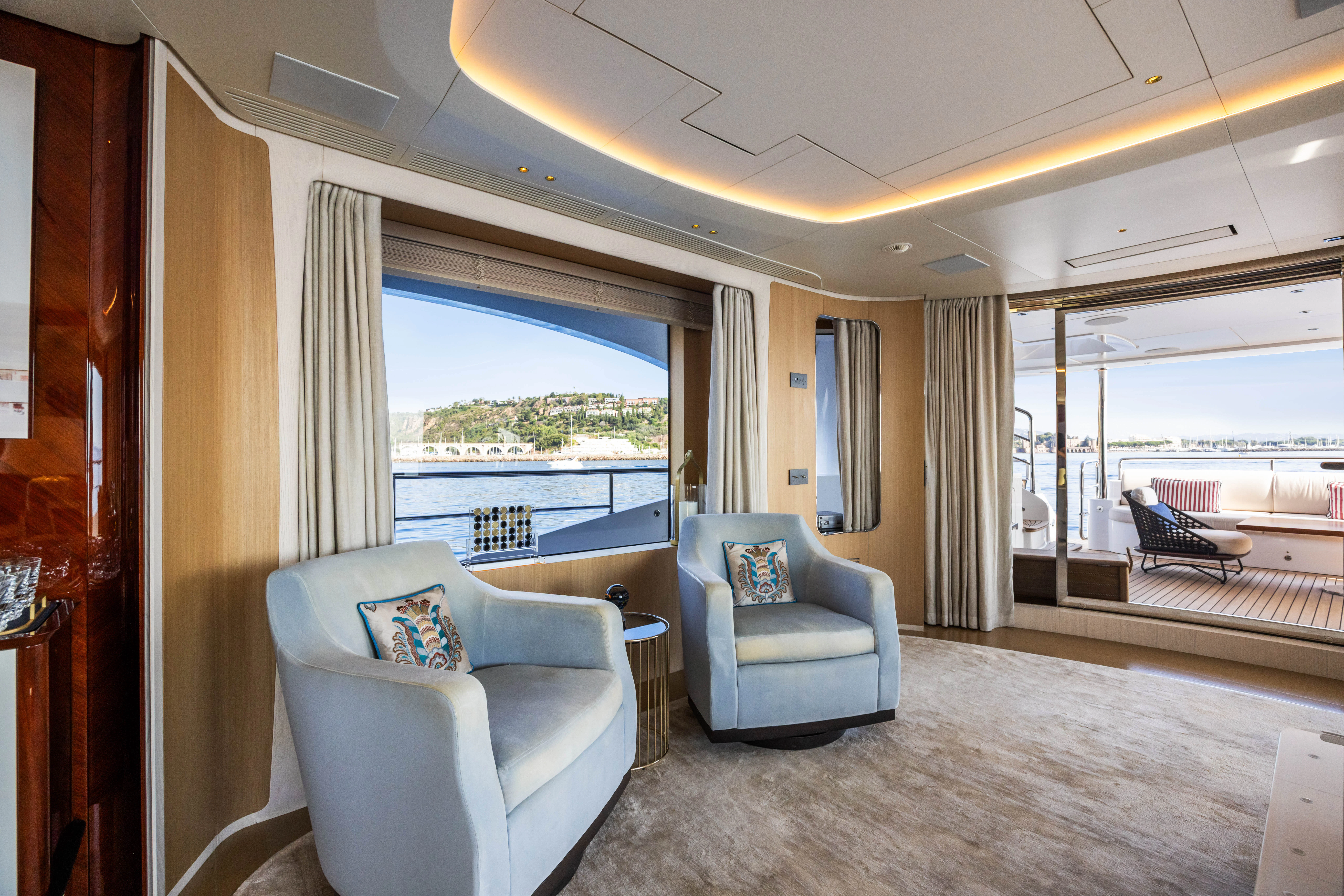 a living room with a large window aboard TRAMONTO Yacht for Charter