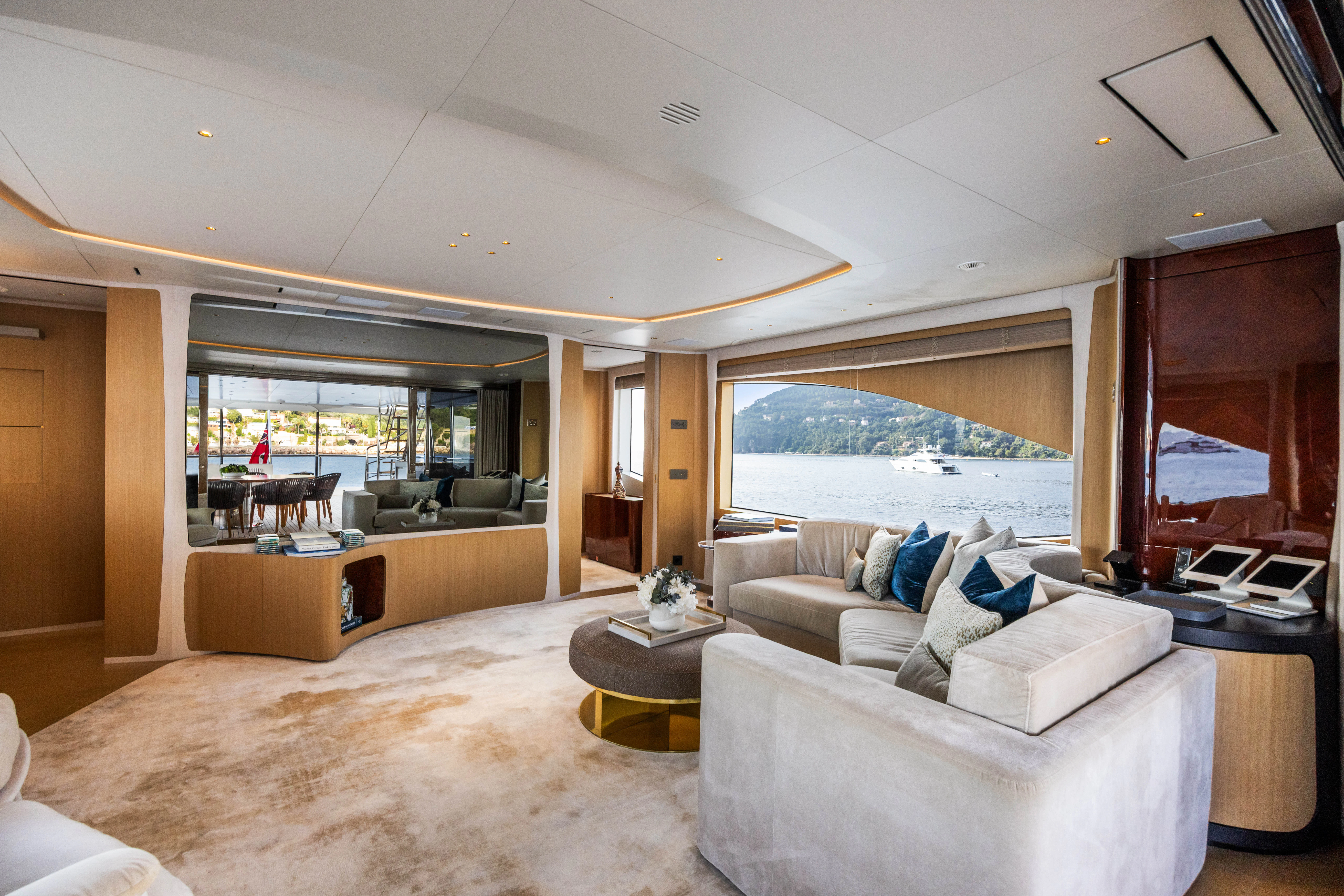 a living room with a large window aboard TRAMONTO Yacht for Charter
