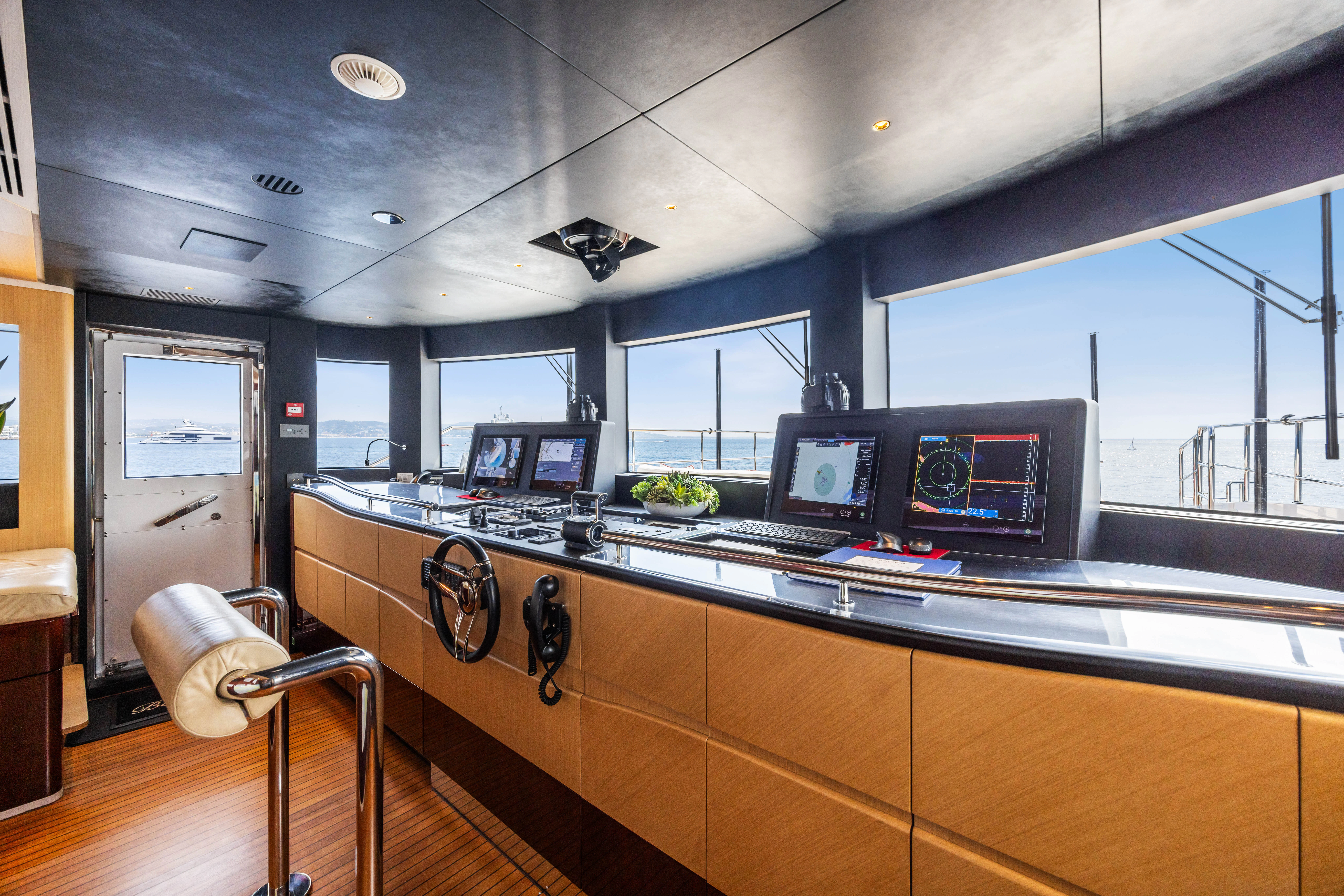 a kitchen with a bar and a table with chairs aboard TRAMONTO Yacht for Charter