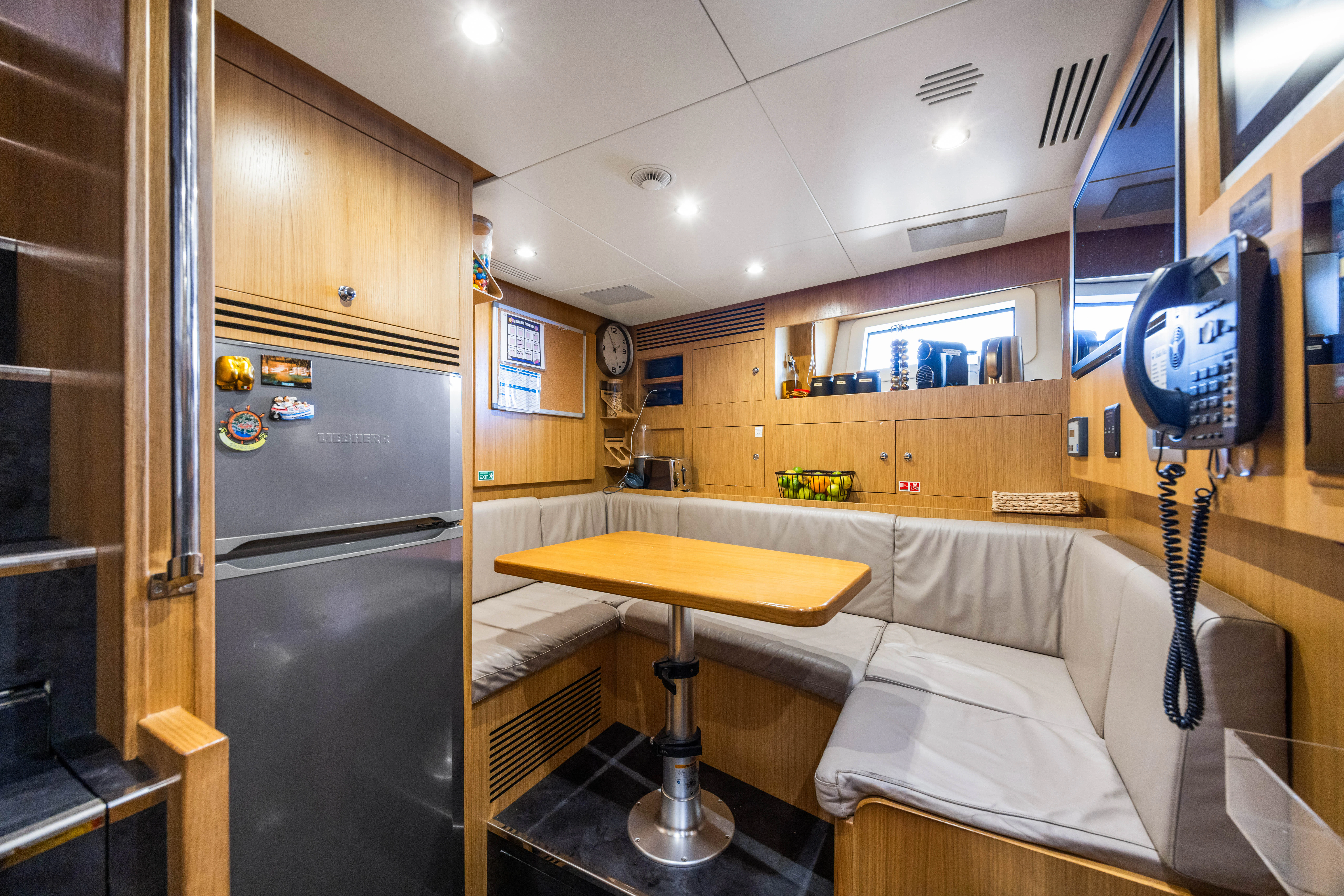 a room with a bed and a desk aboard TRAMONTO Yacht for Charter