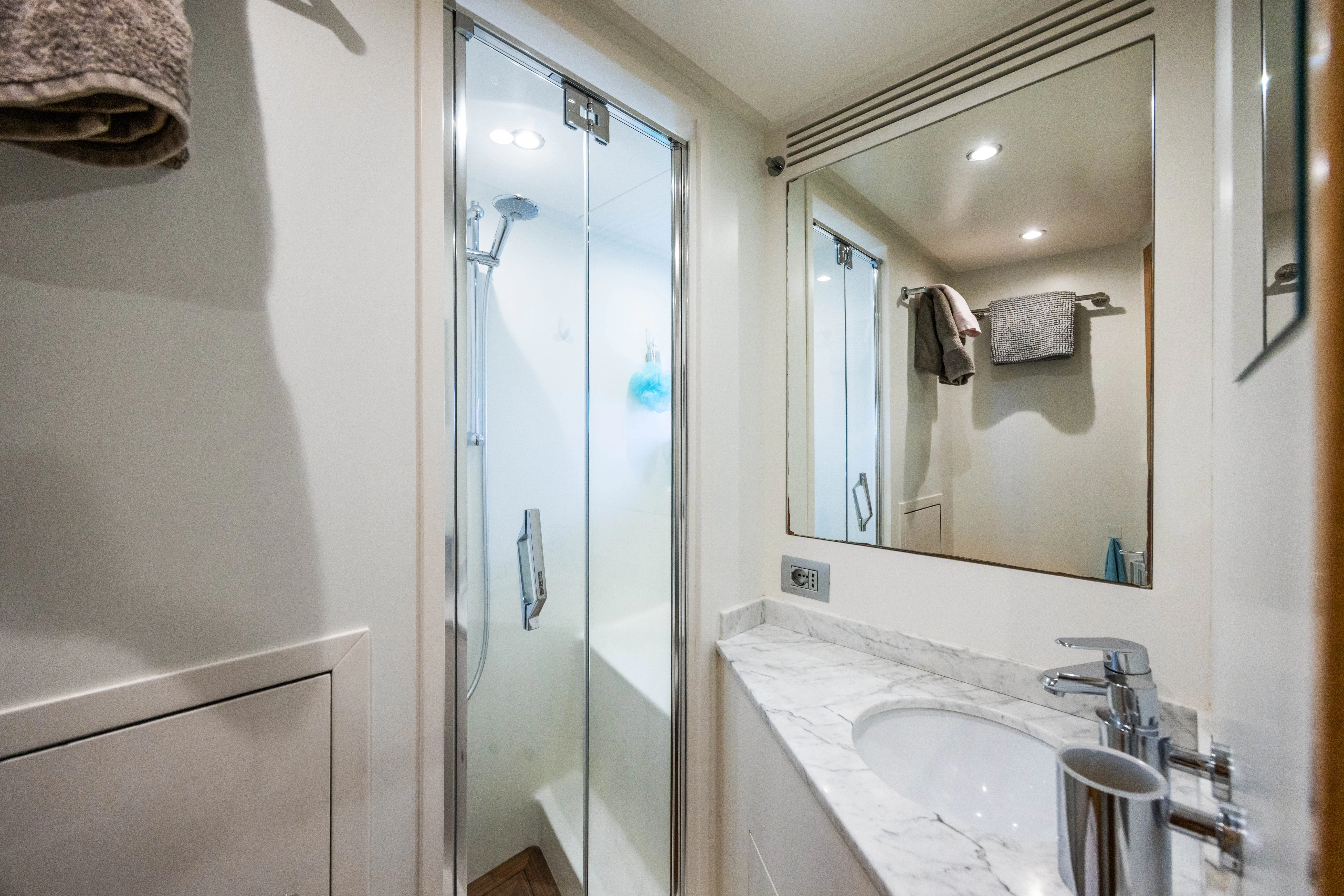 a bathroom with a glass shower door aboard TRAMONTO Yacht for Charter